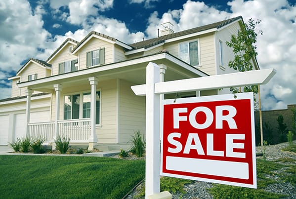 Home with For Sale Sign in Front of House